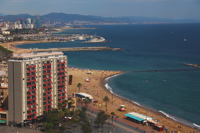 Barcelona coastline with beach, hotel and city skyline – a popular destination for moving and freight to Spain.